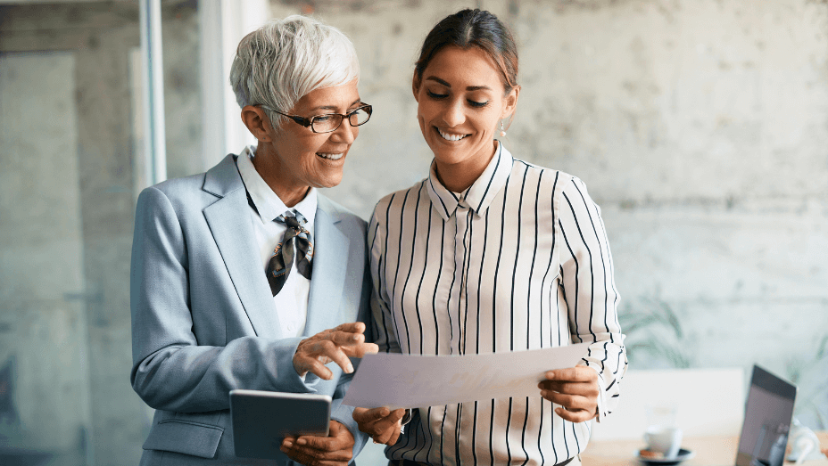 businesswomen-cooperating-while-analyzing-reports