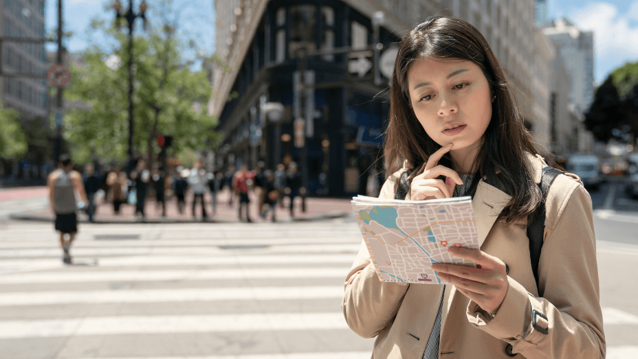 female-studying-map-trying-to-find-the-office