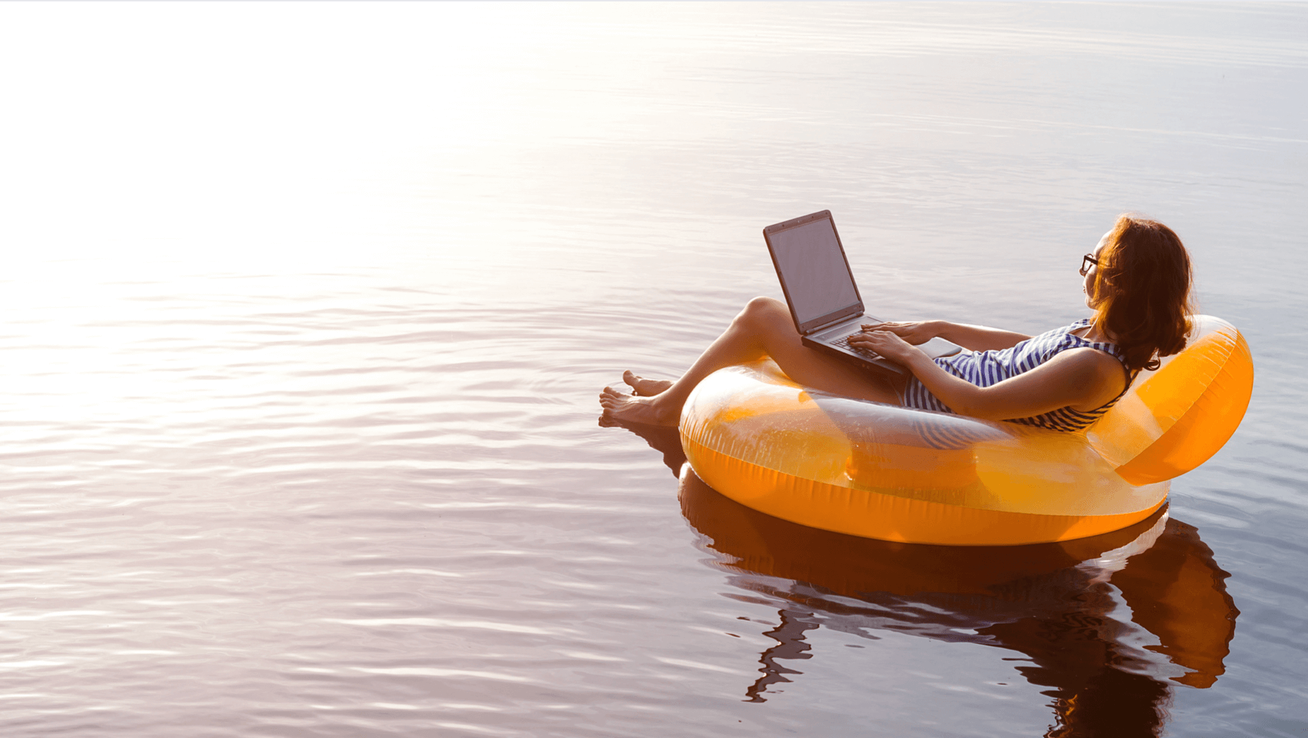 Woman working remotely at the beach